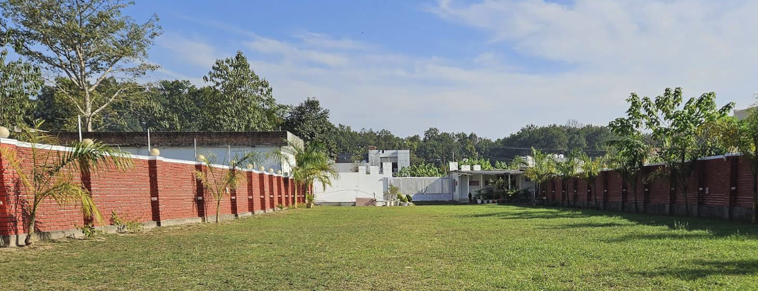 Oxygen Farms expansive green party lawn in Manduwala Dehradun